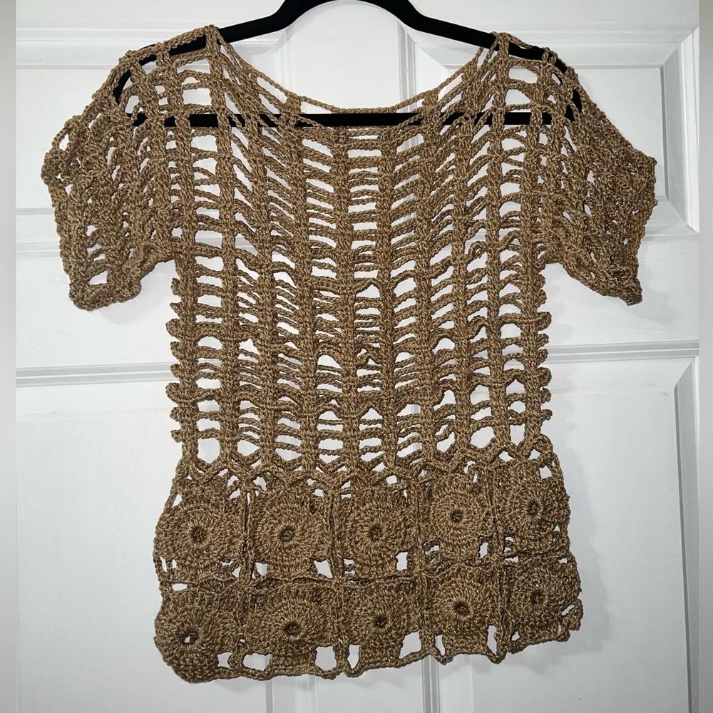 Crochet handmade gold color shirt with ribbed design and flower designs.